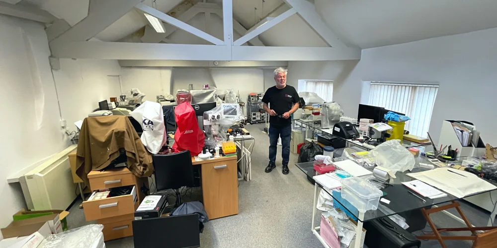 Nick in a room of lab equipment