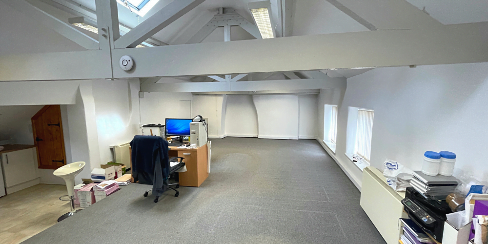 Cleared room, with just a desk and computer on one side