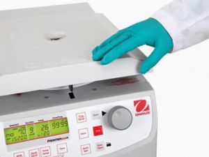 Scientist opening an Ohaus centrifuge
