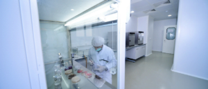 Photograph of scientist working in a fume cupboard