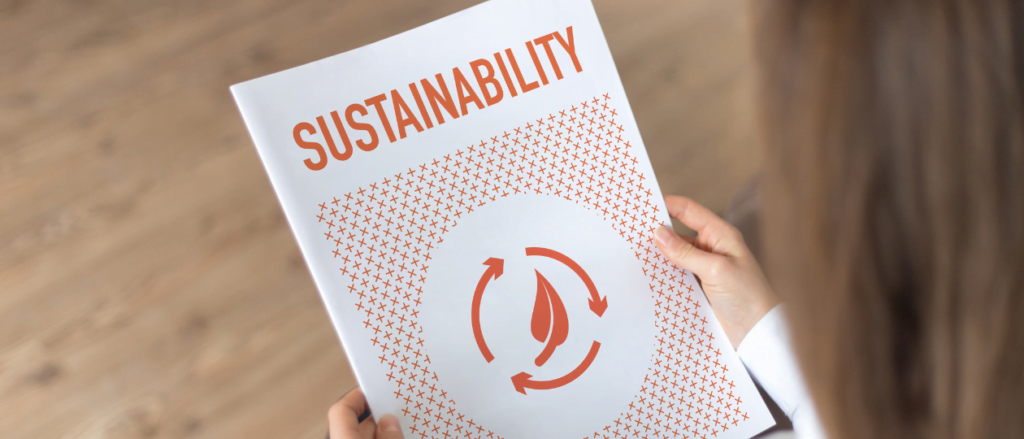 Person holding a report titled Sustainability