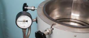 Close up view of top loading autoclave with pressure guauge