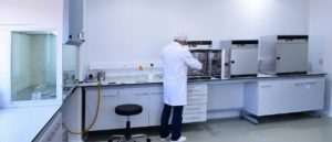 Scientist placing laboratory equipment into an autoclave in the lab