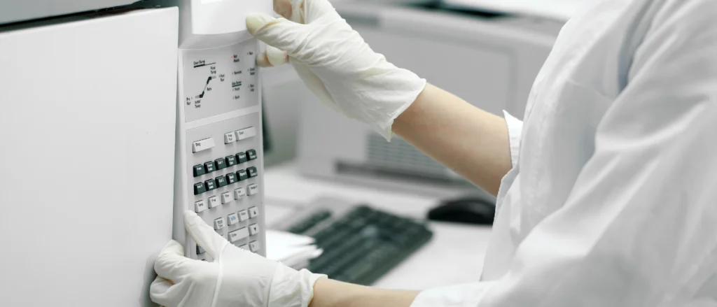 Scientist setting parameters on laboratory oven
