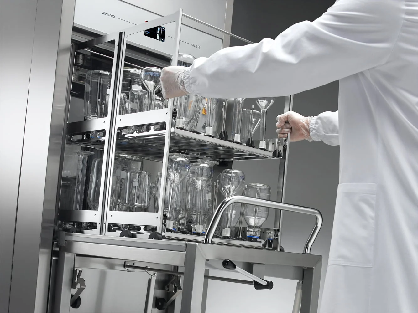 Scientist removing clean glassware from SMEG labwasher