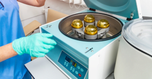 Scientist using centrifuge while wearing gloves