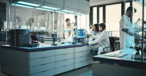 Four scientist are working collaboratively in a lab, with various lab equipment