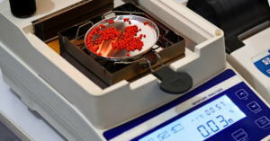 Close up image of moisture analyser containing red sample