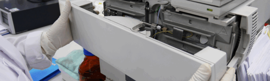 Scientist taking front cover from a second hand HPLC